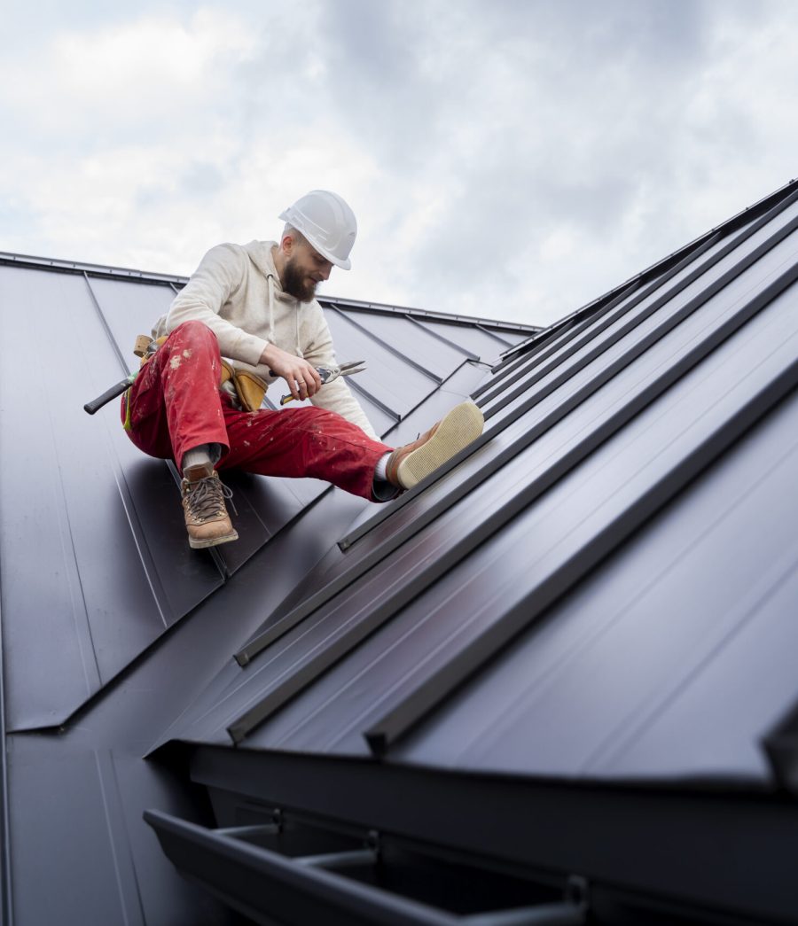 A Technician Repairing Roof of PEB House