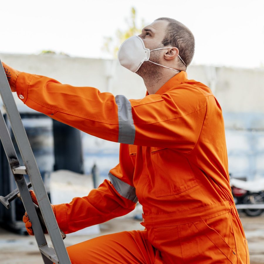 Construction Worker Wearing Orange Uniform and Face Mask
